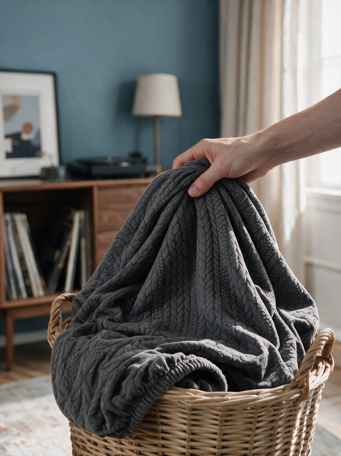 The removable Braelyn - Space Grey cover gathered in a laundry basket