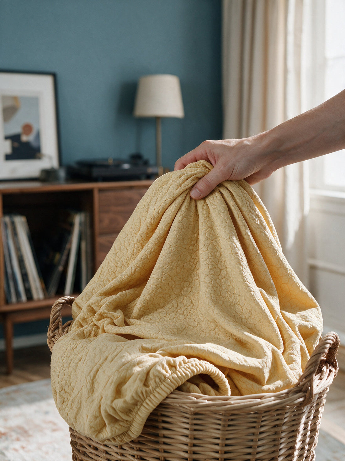 The removable Pebble Textured - Goose Yellow cover gathered in a laundry basket
