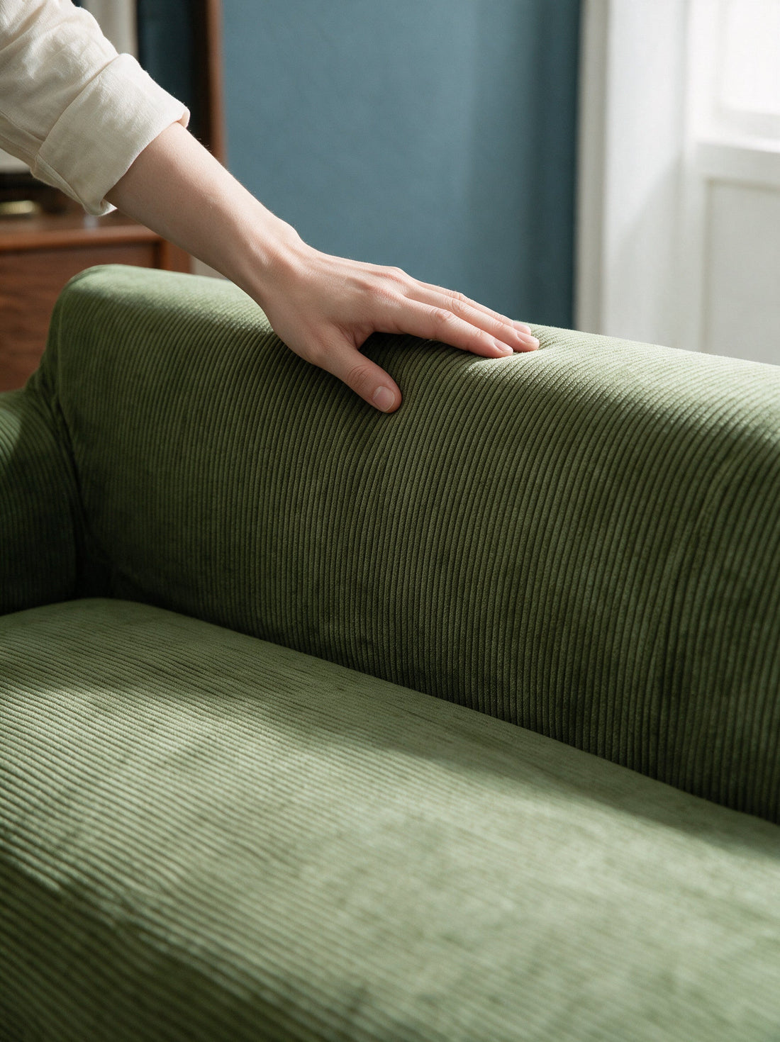 Close-up of the Cordelle - Green cover around a sofa arm