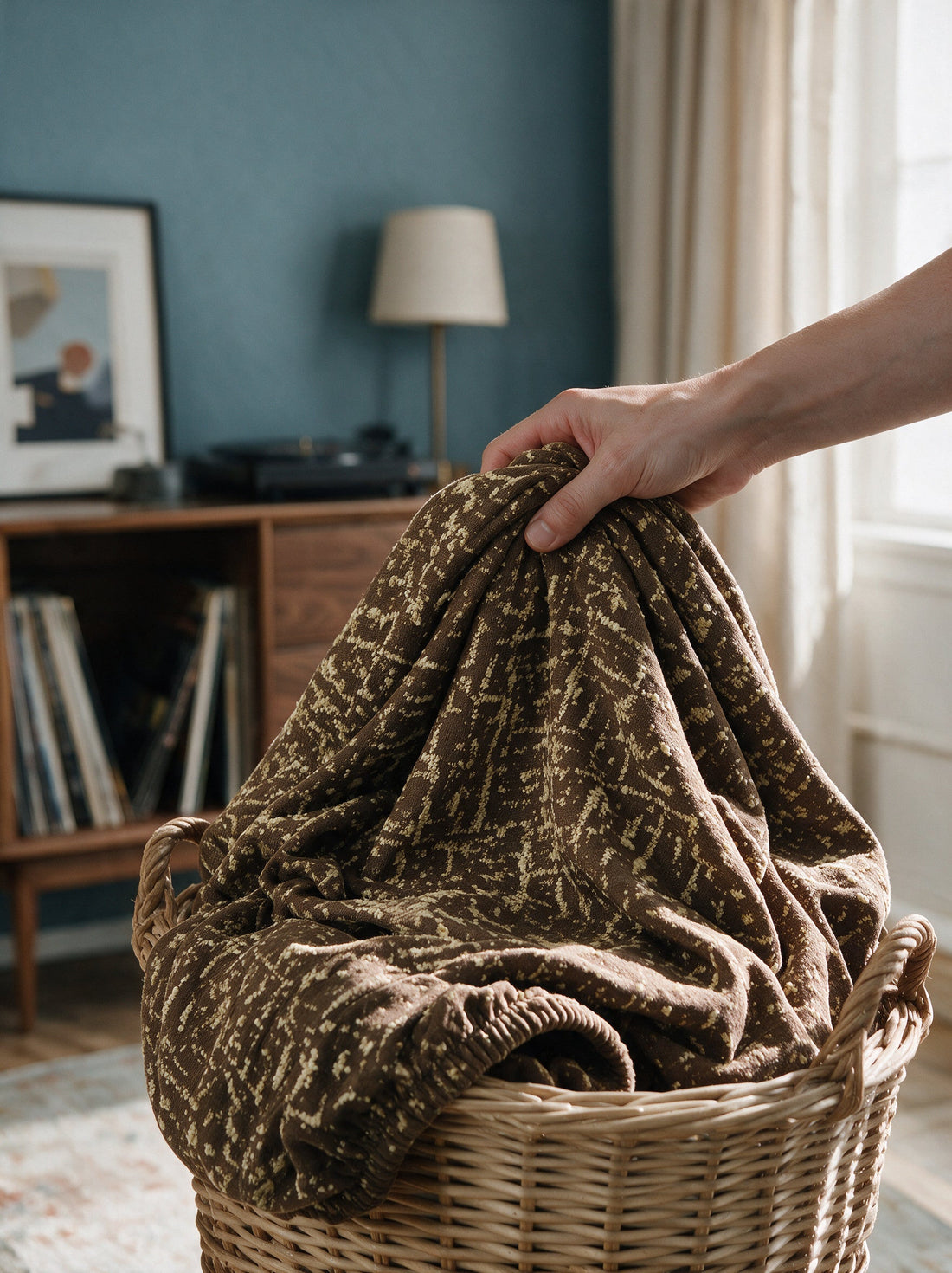 The removable Gridelle - Coffee Brown cover gathered in a laundry basket