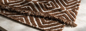 Atlas Geo Cocoa Brown throw fabric detail — AI-generated from product references.