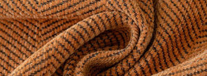 Real Herpome Terracotta Orange fabric gathered into soft folds.