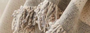 Soft Tassel Dusty Grey: close-up of the original throw fabric.